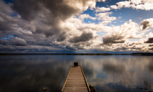 Scenic view of pier over lake against sky