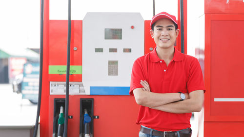 Portrait of man standing at gas station