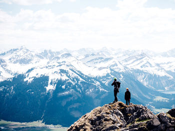 Two men on mountain against sky