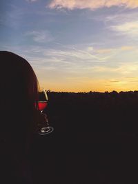 Silhouette woman against sky during sunset