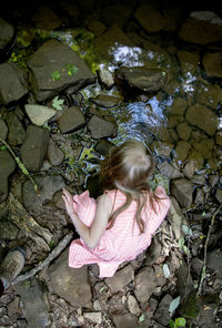 High angle view of girl on rock