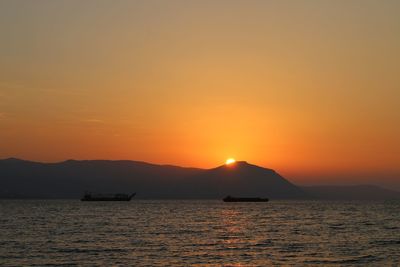 Scenic view of sea against orange sky