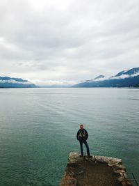 Man standing on pier against sea and sky