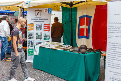 People working at market stall in city