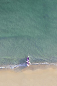 High angle view of a row boat lying on the shore 
