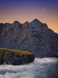 Scenic view of snowcapped mountains against sky during sunset