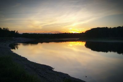 Scenic view of calm lake at sunset