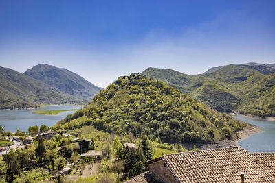 Scenic view of sea and mountains against clear sky
