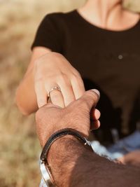 Cropped image of couple holding hands