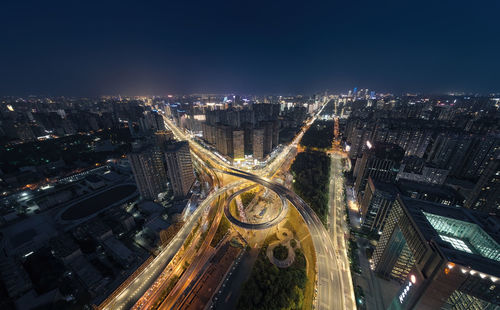 High angle view of illuminated cityscape against sky