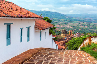 Footpath by houses with cathedral in background