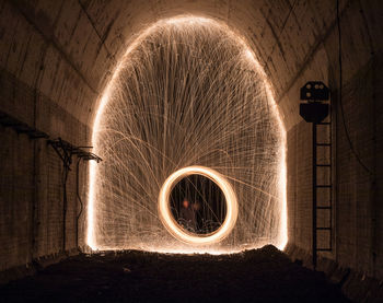 Illuminated wire wool in tunnel at night