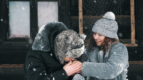 Winter portrait. happy, funny couple in love, man and woman, dressed in warm winter clothes