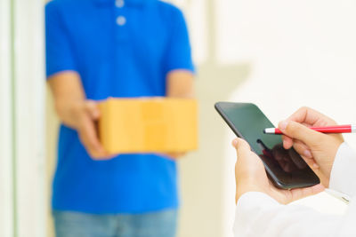 Midsection of woman using mobile phone