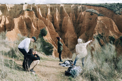 People sitting on rock formation