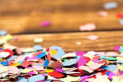 Close-up of multi colored confetti on table