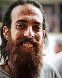 Close-up portrait of smiling mid adult man