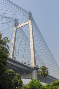 Low angle view of suspension bridge against sky