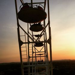 Low angle view of water tower against sky during sunset