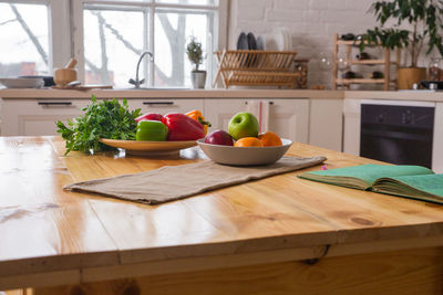 Spices and old recipe book on wooden background on kitchen.