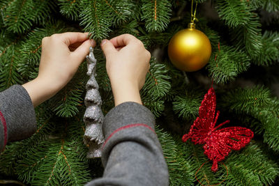 Low section of person holding christmas tree