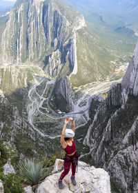 Full length of woman on rocks against mountains