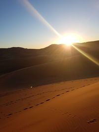 Scenic view of land against sky during sunset