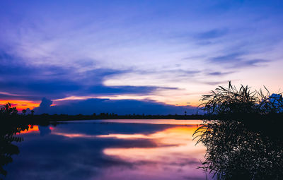 Scenic view of lake against romantic sky at sunset