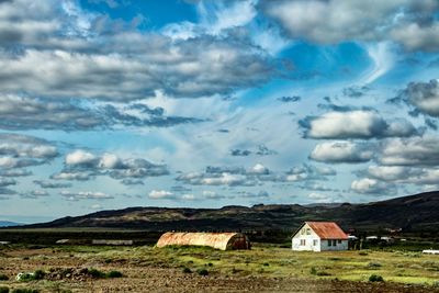 Houses on field against sky