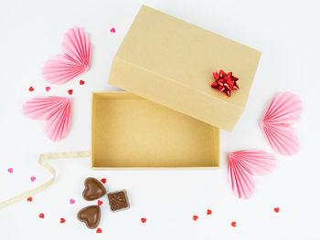 High angle view of various flowers on table against white background