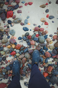Low section of man standing on beach