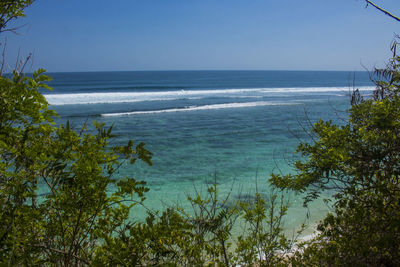 Scenic view of sea against clear blue sky