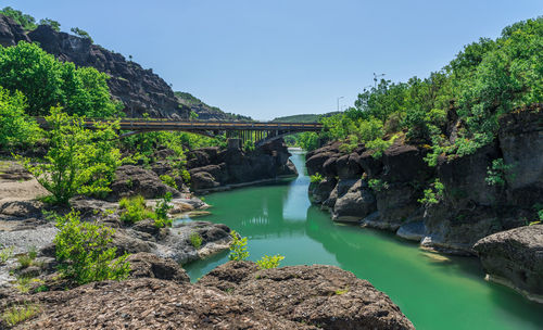 Arch bridge over river against sky