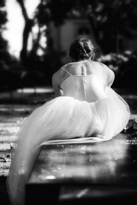 Rear view of girl sitting on bench