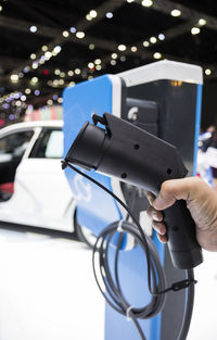 Close-up of hand charging electric car