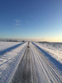 Scenic view of snow covered landscape against sky