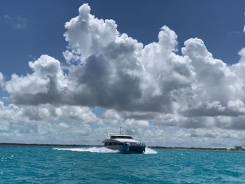 Ship sailing in sea against sky