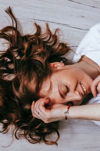 High angle view of woman lying down on bed