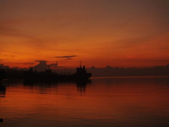 Scenic view of sea against orange sky