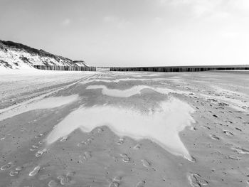 Scenic view of beach against sky during winter