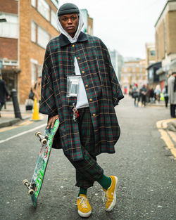 Man with umbrella standing on street