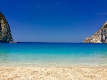 Scenic view of sea against clear blue sky