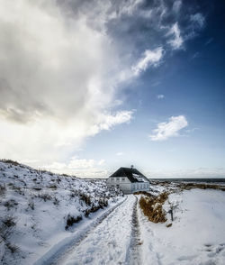 A winter landscape with a house at svinkløv in denmark