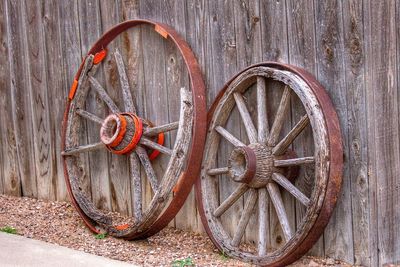 View of rusty wheels on wooden wall