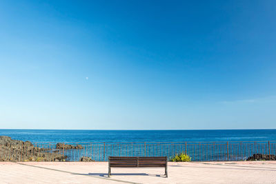 Scenic view of sea against clear blue sky