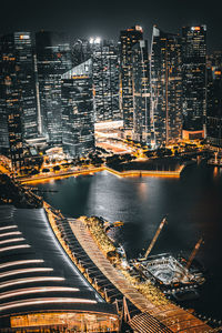 High angle view of illuminated buildings in city at night