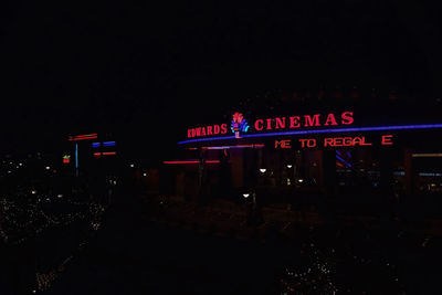 Illuminated sign in city at night