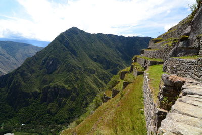 Scenic view of mountains against cloudy sky