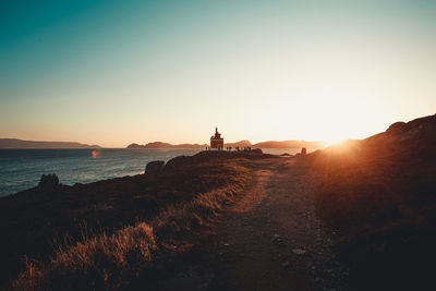 Scenic view of sea against clear sky during sunset