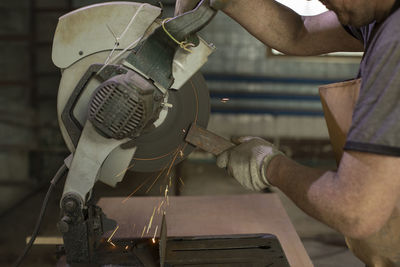 Midsection of man working in workshop